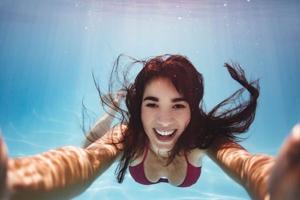 woman looking into the camera under water