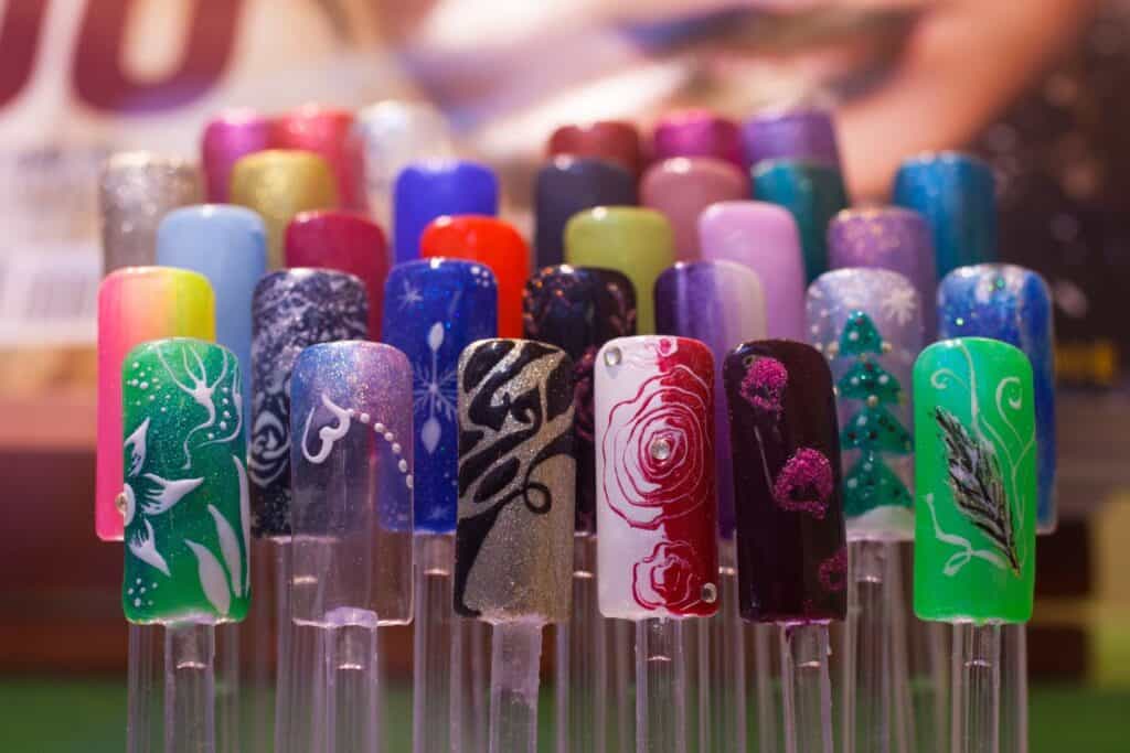 selection of multi-colored fake nails on a stand.