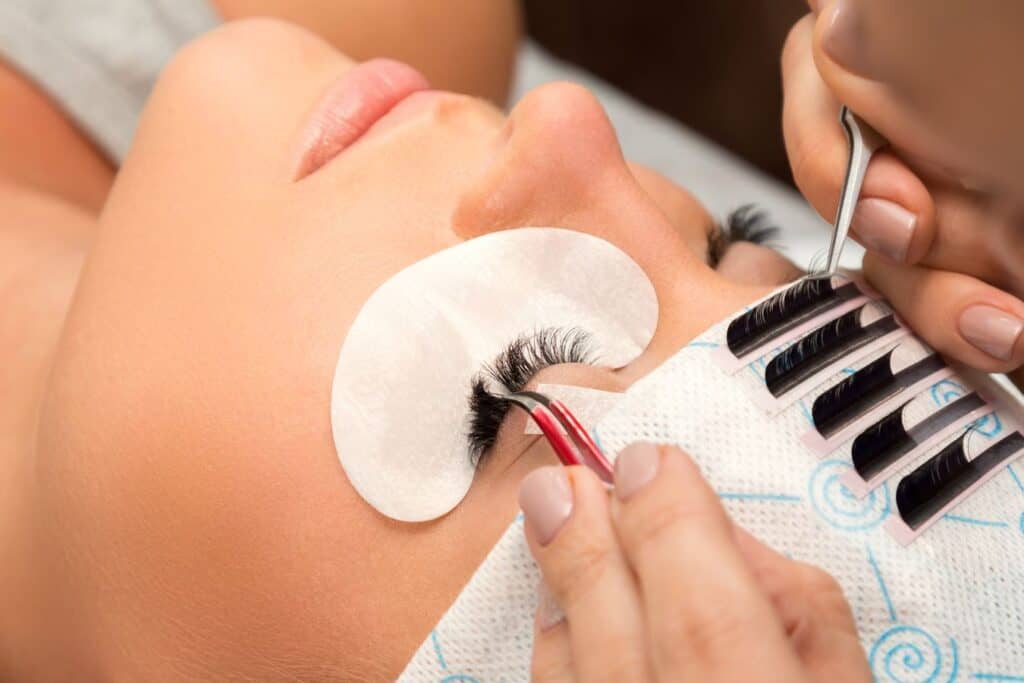 woman having eyelashes done at a salon